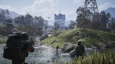 WARDOGS soldiers wading through a river toward a fortified industrial building with a helicopter overhead